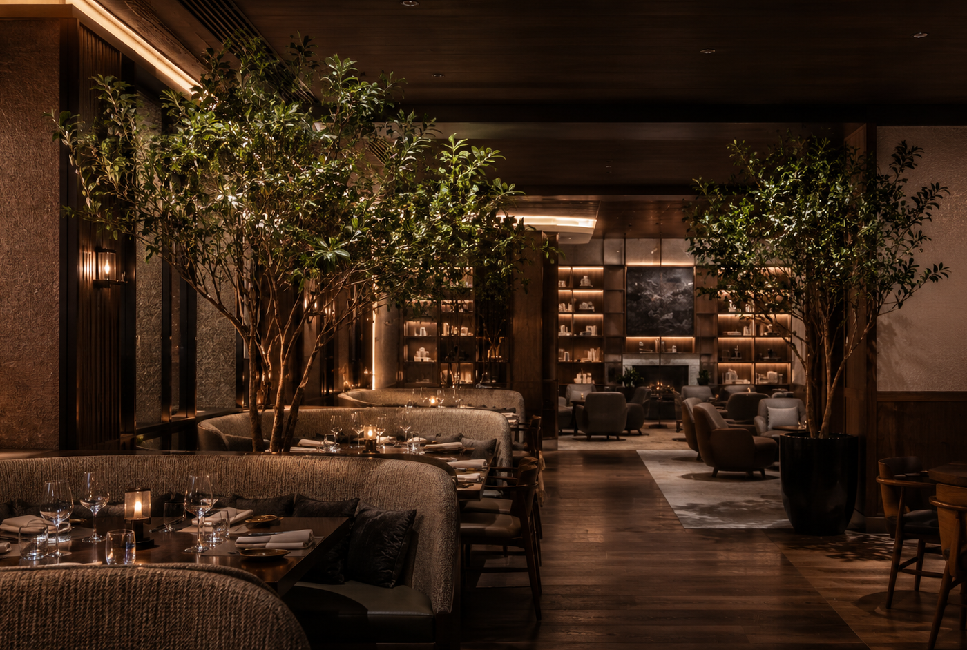 Contemporary restaurant lounge interior with premium faux ficus trees, warm ambient lighting, and modern hospitality styling in Dallas, Texas.